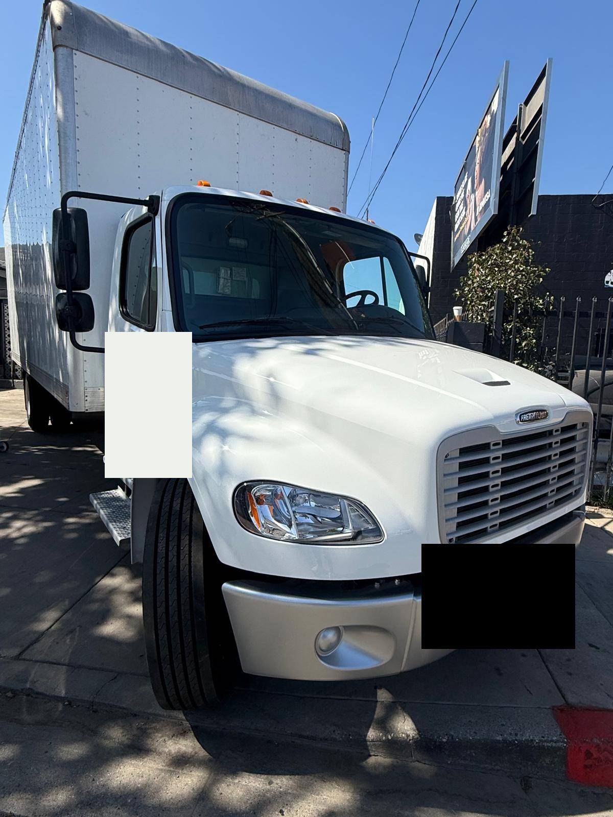 White Freightliner commercial truck after body repair at BG Auto Body