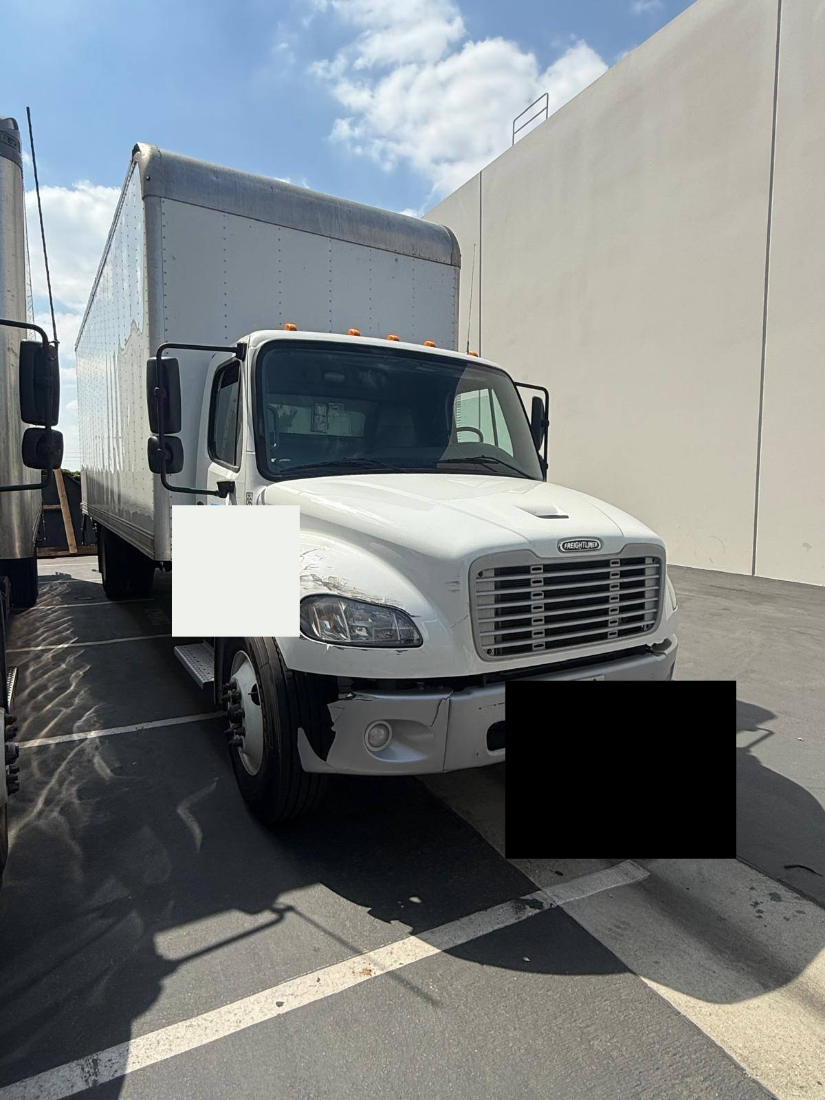 White Freightliner commercial truck before body repair at BG Auto Body